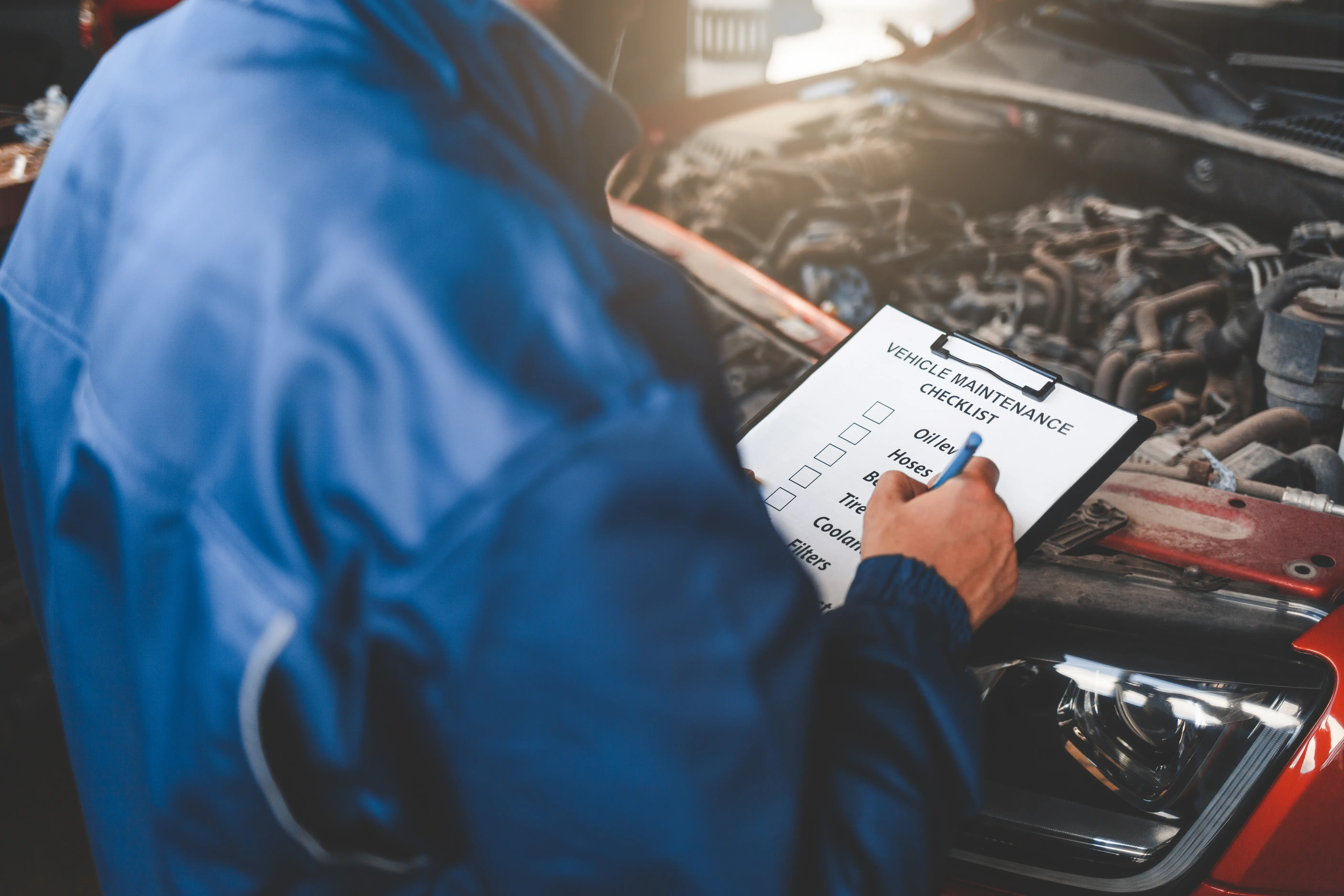 A Mechanic Doing Auto Preventive Maintenance Checklist