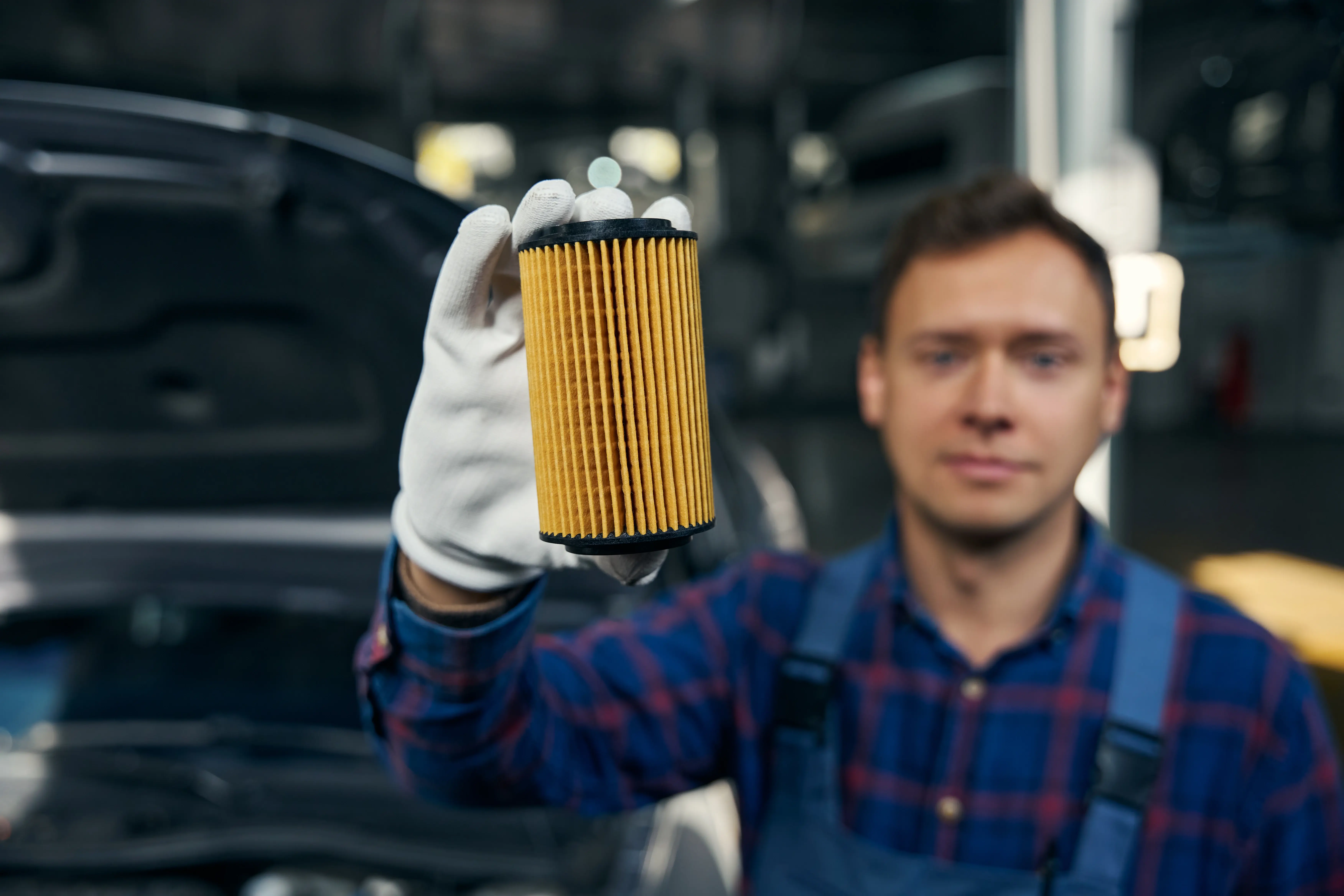 Man Holding Auto Oil Filters
